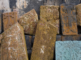 Armenian khachkars at the wall of an ancient monastery. Stone steles with carvings, a national...