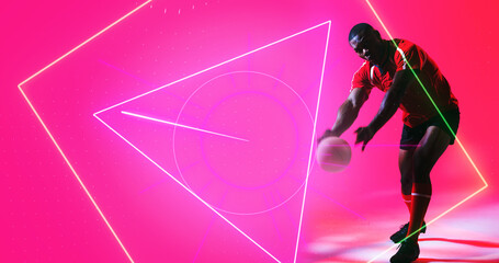 Illuminated geometric shapes over african american player holding ball on pink background