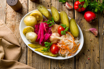 plate of pickles top view on wooden table