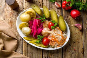 plate of pickles top view on wooden table