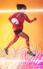 Biracial female rugby player holding ball and jumping over illuminated line and plants