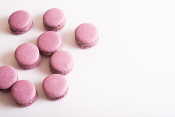 Obraz na płótnie Canvas Pink macaron cookies. Isolated on white background. Tasty dessert. Copy space
