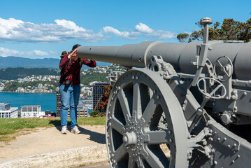 Tourist looking into cannon at Botanic garden hill in Wellington