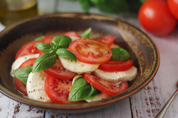 A bowl with traditional Italian caprese salad	