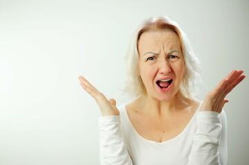 Frustrated and furious adult woman gestures grimacing angry woman screaming Screaming, hate, rage. Crying emotional angry woman screaming Female half-length portrait. Human emotions