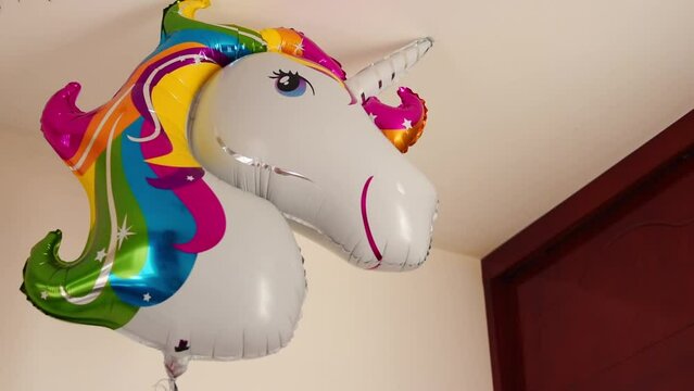 Colorful unicorn balloon in room