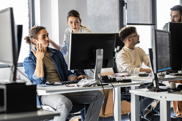 Group of programmers and game developers working on a new project at the office.	
