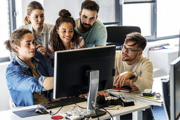 Group of programmers and game developers working on a new project at the office.	
