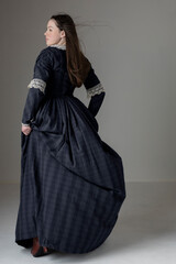 Naklejka premium A young Victorian woman wearing a blue cotton dress with lace trim