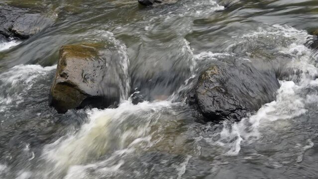 Water flowing through a rocky river in Cumberland Mountain Tennessee shows the peaceful, surreal tone of being in the wilderness.