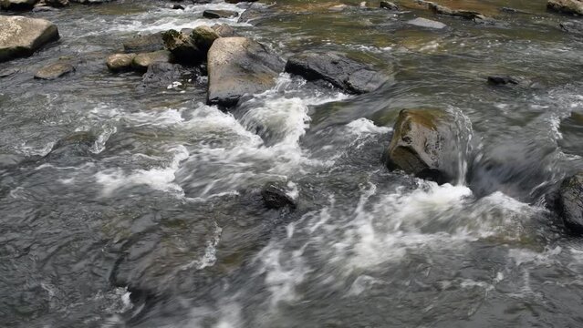 Water flowing through a rocky river in Cumberland Mountain Tennessee shows the peaceful, surreal tone of being in the wilderness.