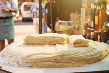 stacks of thin turkish lavash bread selling on farmers market at Turkey. High quality photo