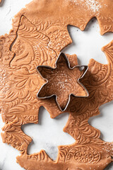 Baking ingredients for Christmas patterned cookies and gingerbread. Xmas sweet, winter holidays concept, new year treet. Vertical orientation, top view