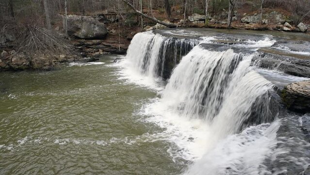 Beautiful Potter's Falls in Tennessee's Cumberland Plateau flows across shallow pools of water and over the cliff to form a beautiful water symphony and natural patterns.