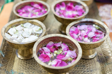 purple rose and white jasmine flowers put into water as a requirements before Siraman ritual in...