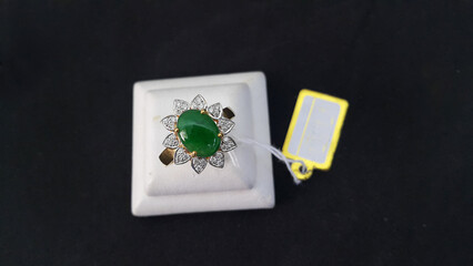 A gold ring embellished with green jade lay on the ground.