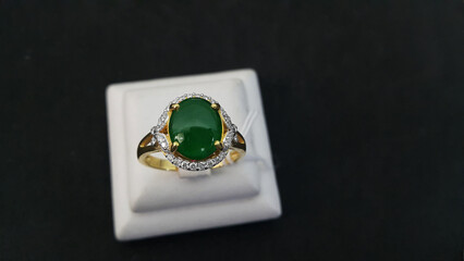 A gold ring embellished with green jade lay on the ground.