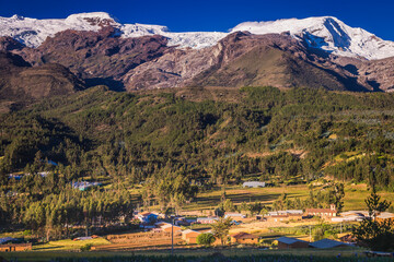 Fototapeta na wymiar Village and Huascaran in Cordillera Blanca at sunrise, snowcapped Andes