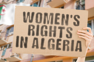 The phrase " Women's rights in Algeria " is on a banner in men's hands with blurred background. Cheering. Community. Confidence. Courage. Crowd. Defend. Determination. Different. Diversity. Fight