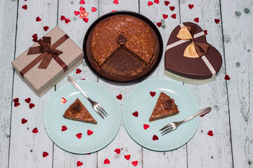 Chocolate cake served for two with gift for Valentine's Day