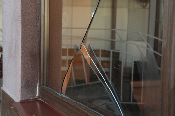 Broken window with sharp smithereens outdoors. Requiring repair - obrazy, fototapety, plakaty