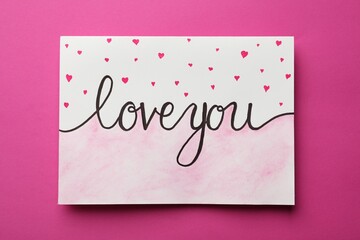 Card with phrase Love You and drawn little hearts on pink background
