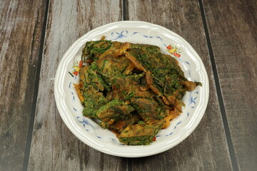 Fried Egg with Climbing Wattle or acacia eggs serving on the plate. Famous side dish menu in Asia restaurant. 