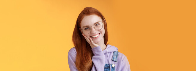 Smiling satisfied happy redhead girl get rid acne delighted touching soft clean skin laughing...
