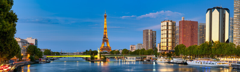 Sunset skyline panorama of Paris with Eiffel Tower near Seine river