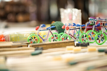 A green color cycle toy showpiece handmade with aluminium children toys in green color selling in market, fair, mall, or store