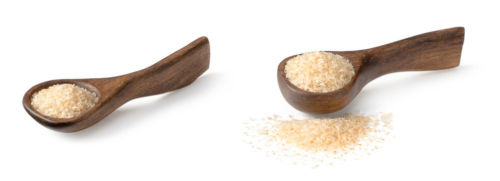 Psyllium husks in the wooden spoon, isolated on white background.