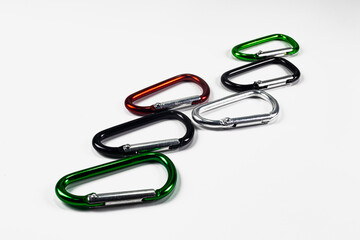 Six small colored carabiners on a white background