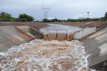 Stormwater runoff flowing in an open channel system after heavy rain in Mesa, Arizona, in 2018