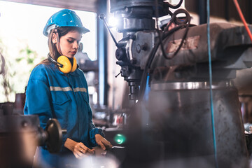 young woman smiling and working engineering in industry.Portrait of young female worker in the...
