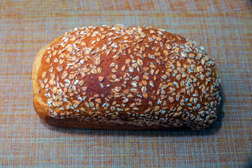 fresh baked oatmeal loaf lies on the table