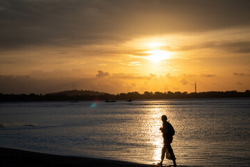 Fototapeta premium sunset walk on the beach in tropical indonesia