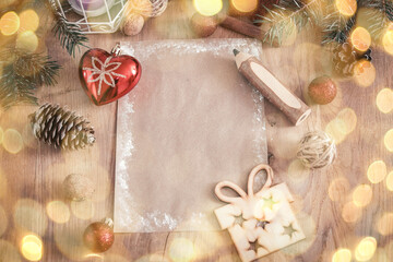 Fototapeta na wymiar Christmas blank card on wooden background. retro style. beautiful bokeh effect from a garland.