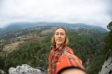 Fototapeta na wymiar selfie of a woman on the background of a rocky and mountainous area.