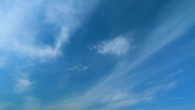Blue sky with beautiful cirrocumulus clouds. Beautiful sunny blue sky background with cirrus clouds. Timelapse.