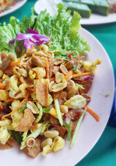Thai Food, Three Crispy Spicy and Sour Salad Mix with crispy pork, peanuts and mango.