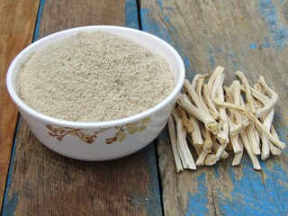 Asparagus racemosus or shatavari powder in a bowl on wooden background 