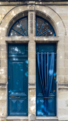 blue wooden front two doors of street restored house entrance facade classic gate