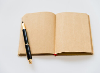 Blank organizer book and pen on table.