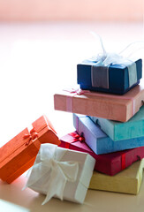 Stack of colorful gift box on table.