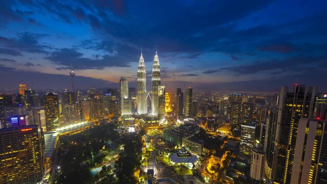 Aerial high angle time lapse of golden sunrise with a wide angle view of a skyline at dawn in Kuala Lumpur, Malaysia. Prores 4K DCI
