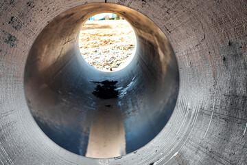 Modern water supply and sewerage system. Underground pipeline works. Water supply and wastewater disposal of a residential city. Close-up of underground utilities. View from the big pipe.