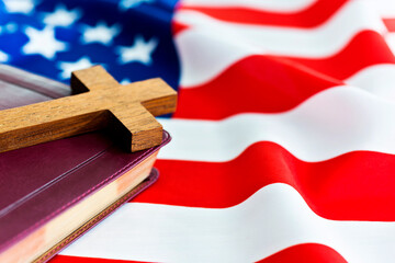 Holy bible with a cross on american flag