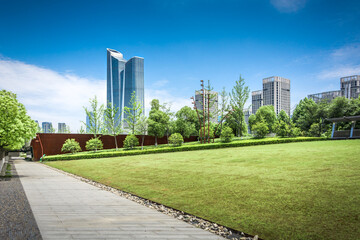 Modern city buildings, park foreground
