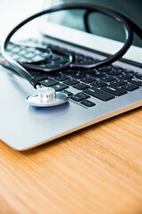Stethoscope on keyboard of laptop