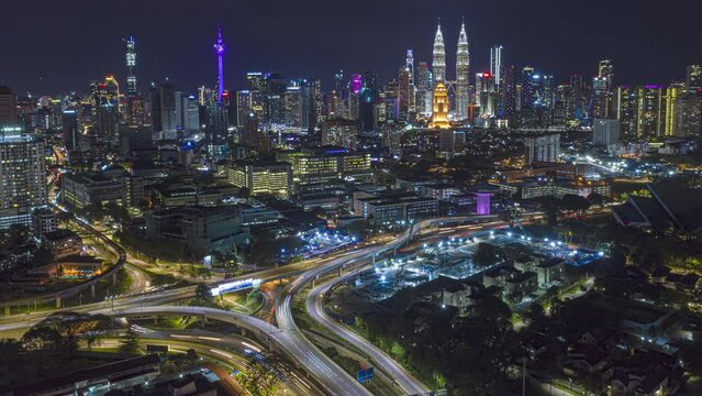 Malaysia Time lapse: Aerial city during night overlooking Kuala Lumpur city skyline and the Kuala Lumpur General Hospital with busy roundabout and streets. Prores 4KUHD